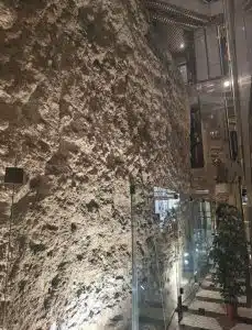 Medieval Fernandine wall preserved inside a modern shopping centre in Chiado, Lisbon.