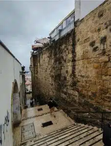 Stone remains of Lisbon's Moorish wall beside Portas do Sol in Alfama.